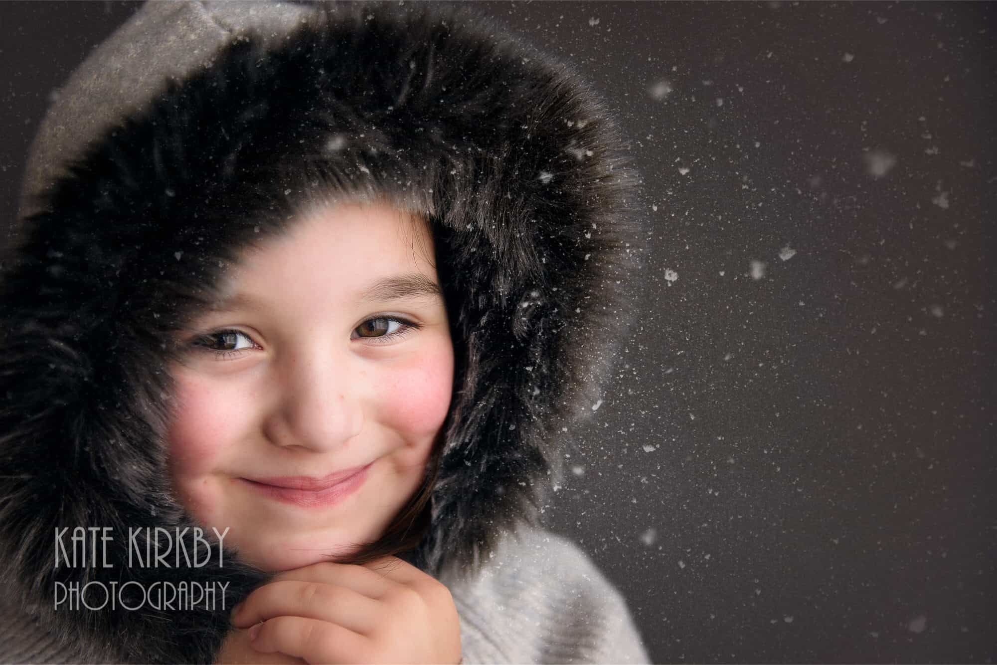 girl in fur hood smiling