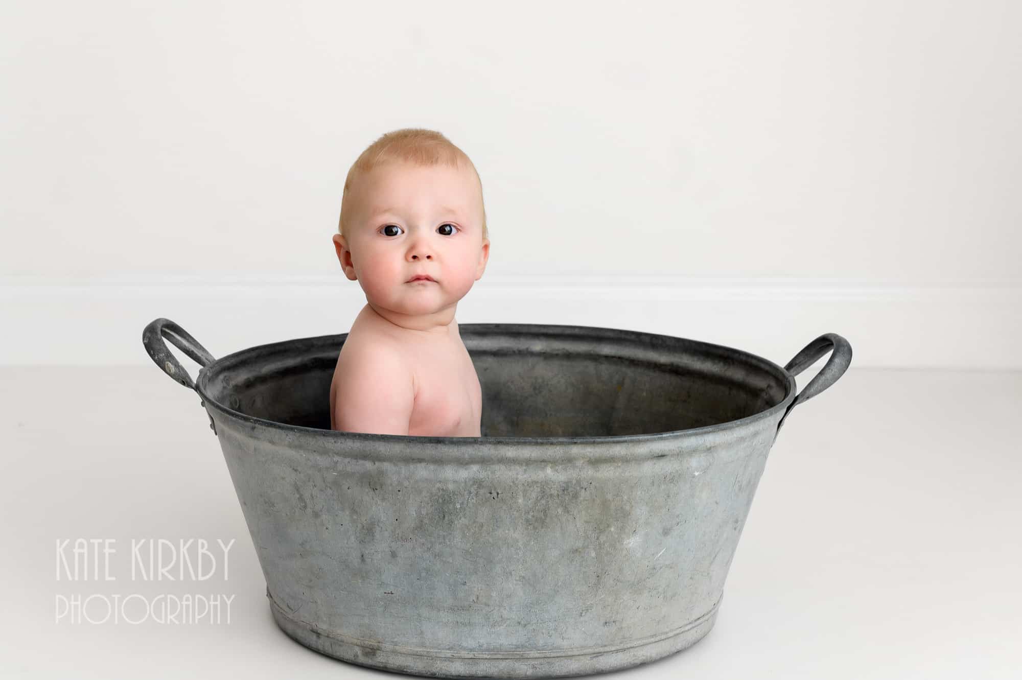 10 month old sitting in tin bath