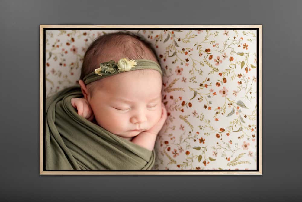 framed photo of baby on green