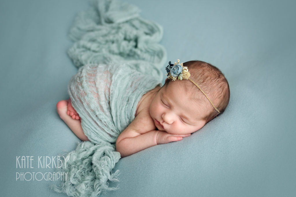 newborn girl in baby blue