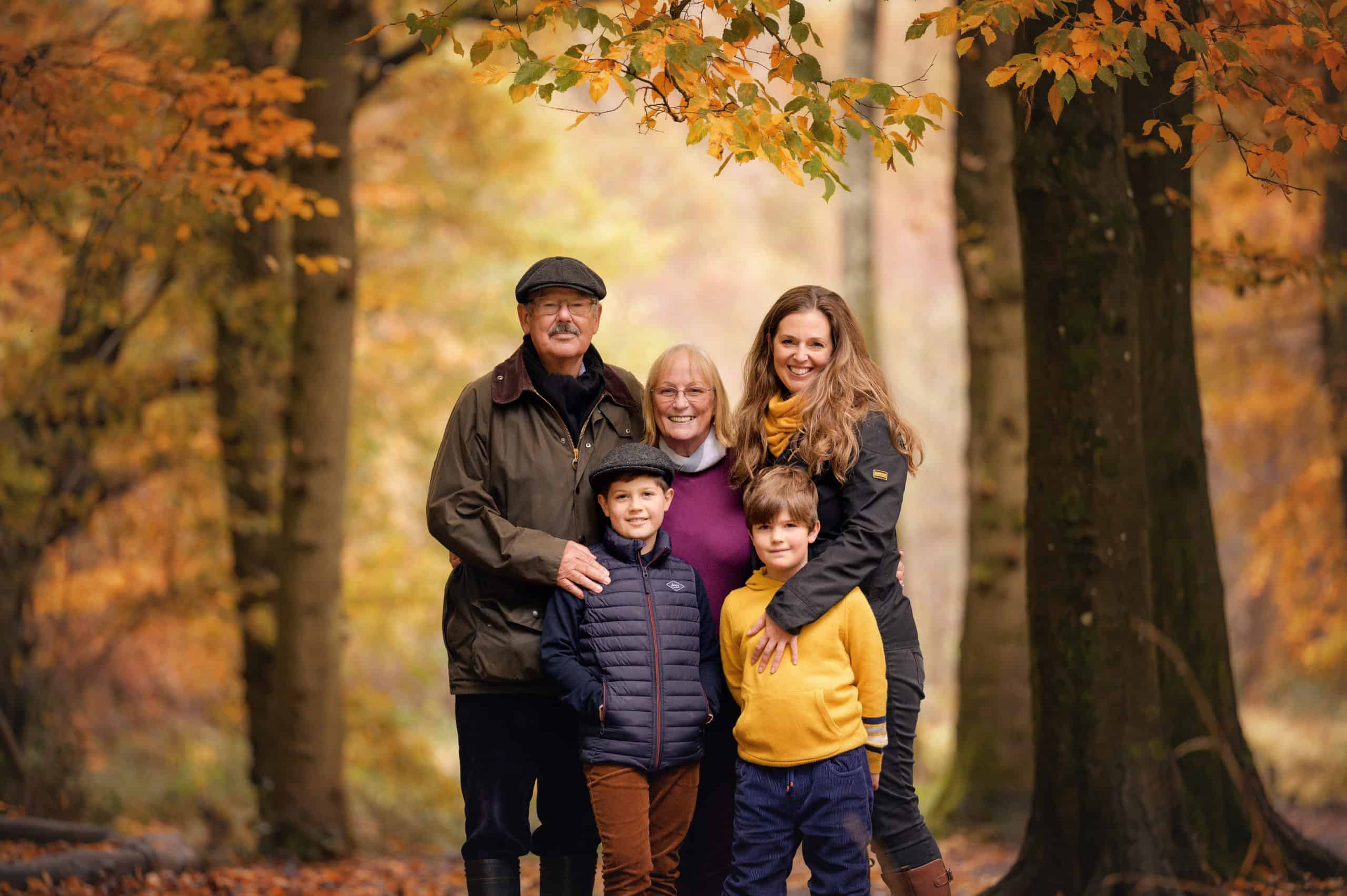 family with grandmother in autumn woodland family photoshoot