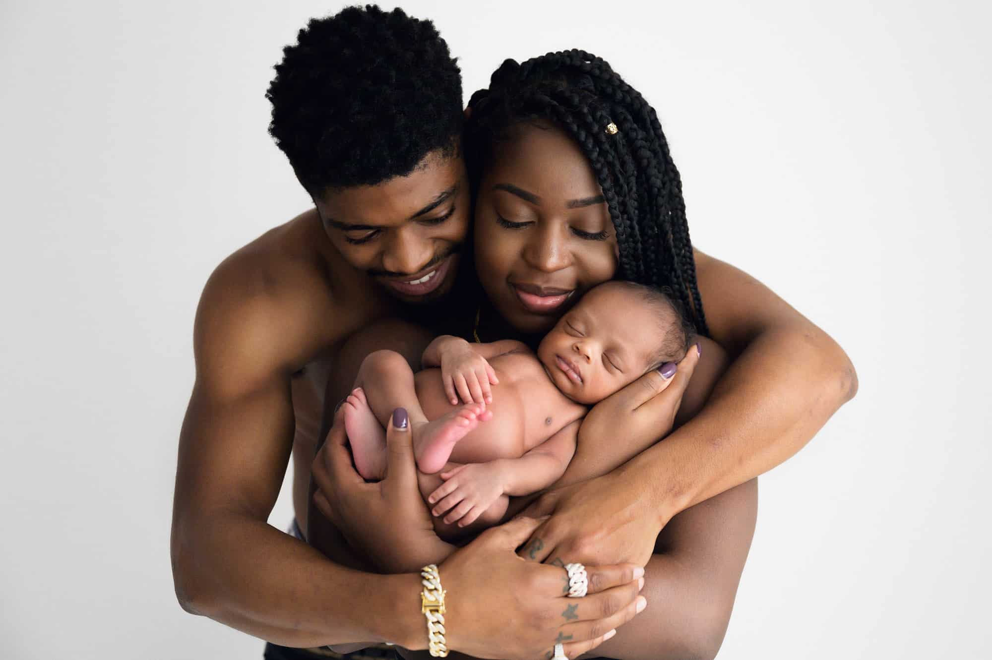 photograph of New parents holding newborn baby in studio near portishead