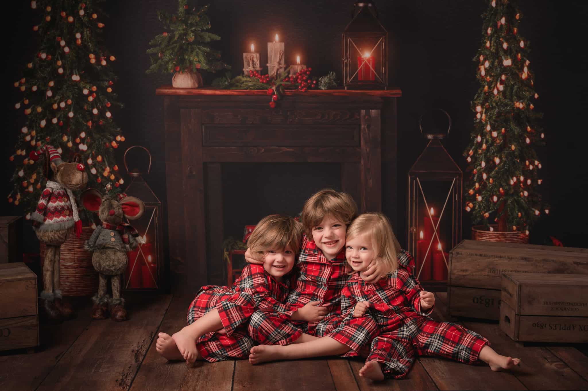 Christmas photo of children sitting by the fire